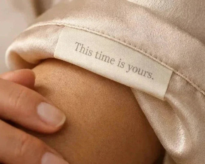 Close-up of a soft sleepwear label that reads “This time is yours,” representing menopause sleepwear designed for comfort, recovery, and self-care.